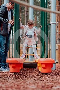 Family time in the park. Father have fun with his daughter in the park, playing fun games and spending time together