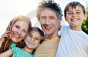 Family time is precious to us. Portrait of a happy family spending time together outdoors.