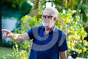 Family time together at home concept. lifestyle. Portrait of happy and handsome bearded senior man in glasses enjoy nature garden
