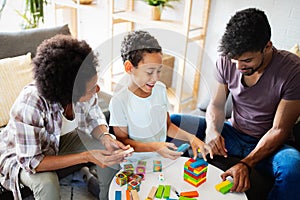 Family time. Young black parents with two kids playing together at home