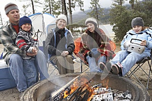 Family Toasting Marshmallow At Campfire