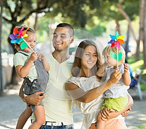 Family with toy windmills at park