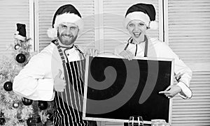 Family traditional menu for christmas dinner. Menu for our family. Man and woman chef santa hat near christmas tree hold