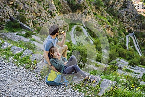 family travel - father and son hiking in mountains of Montenegro, Kotor