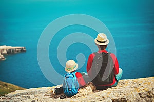 Family travel - father and son hiking in nature