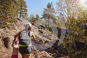 Family travel. Strong mother helps her daughter climbing