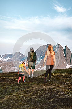 Family travelers hiking in mountains parents and child climbing together healthy lifestyle active adventure vacations