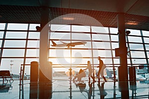 Family traveling with children, silhouette in airport photo