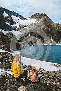 Family traveling together mother and kid hiking outdoor in Norway, active healthy lifestyle adventure vacations