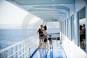 Family travelling on cruise ship on sunny day Family and love concept. Father, mother and child stand on deck of cruise