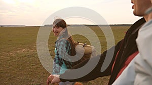 Family travels with dog on plain. come after me. Dad with a small daughter in his arms travels with children and a pet