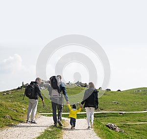 Family on a trekking day in the mountains. Velika Planina or Big