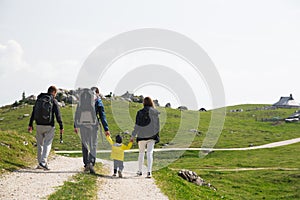 Family on a trekking day in the mountains. Velika Planina or Big