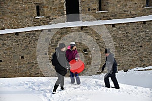 Tourist hiking in the ruins castle on the snow in Slovakia Zborov ruins