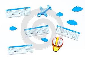 Family trip concept. Airplan toy, air balloon cookie, airplan tickets on white background top view