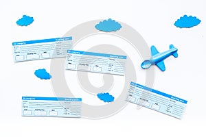 Family trip concept. Airplan toy, clouds, airplan tickets on white background top view