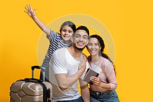 Family Trip Concept. Excited Middle Eastern Parents Travelling With Their Little Daughter