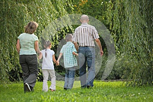 Family with two children in early fall park.