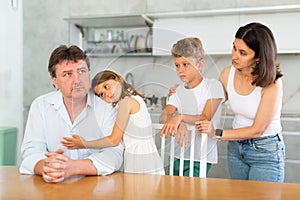 Family with two children in kitchen during quarrel