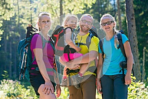 Family with two daughters on hike in the woods