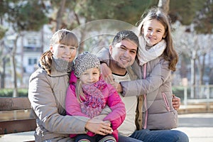 Family with two girls outdoors in sunny fall day