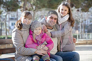 family with two girls outdoors in sunny fall day