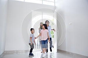 Family with two kids entering their new house