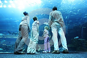 Family in underwater aquarium tunnel