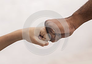 Family Unity. Fist bump of black man and little boy