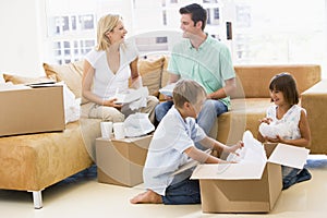 Family unpacking boxes in new home smiling photo