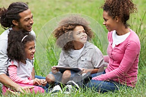 Family Using Digital Tablet Whilst Hiking In Countryside