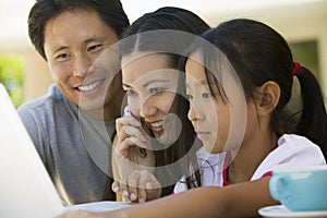 Family Using Laptop in backyard