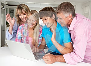 Family using laptop at home