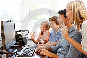 Family using skype in home office photo