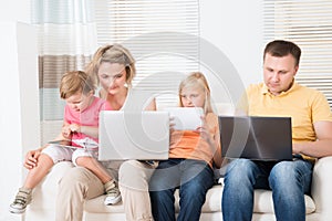 Family Using Tablets and Computers