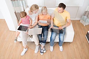 Family Using Tablets and Computers