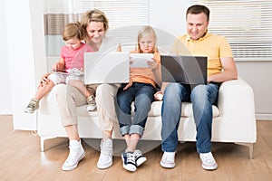 Family using tablets and computers