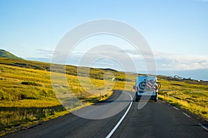 Family vacation cycle on a bus , road trip in a highway, green peaceful travel Eurotrip Iceland photo