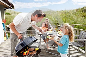 Family on vacation having barbecue