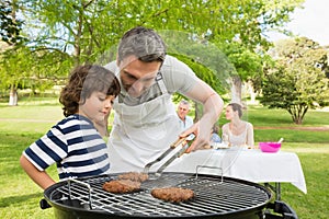 Family on vacation having barbecue