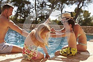 Family On Vacation Having Fun By Outdoor Pool