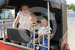 Family on vacation, mother and kids sitting in tuk-tuk, having fun