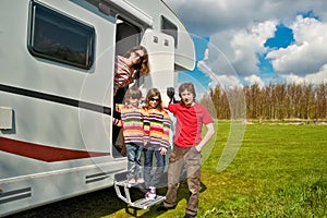 Family vacation, RV travel with kids, happy parents with children have fun on holiday trip in motorhome, camper