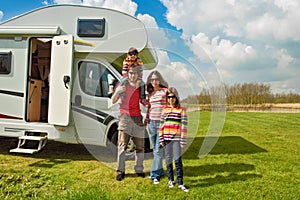 Family vacation, RV travel with kids, happy parents with children have fun on holiday trip in motorhome, camper exterior