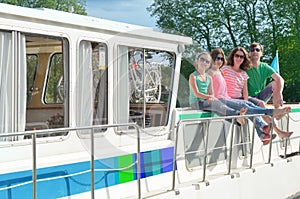 Family vacation, summer holiday travel on barge boat in canal, happy kids and parents having fun on river cruise trip in houseboat