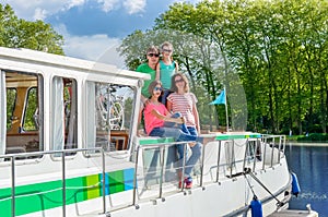 Family vacation, summer holiday travel on barge boat in canal, happy kids and parents having fun on river cruise trip in houseboat