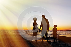 Family vacation. Sunset at sea. Silhouette