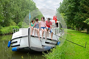 Family vacation, travel on barge boat in canal, happy kids having fun on river cruise trip