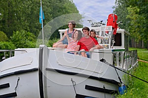 Family vacation, travel on barge boat in canal, parents with kids having fun on river cruise