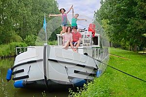 Family vacation, travel on barge boat in canal, parents with kids having fun on river cruise